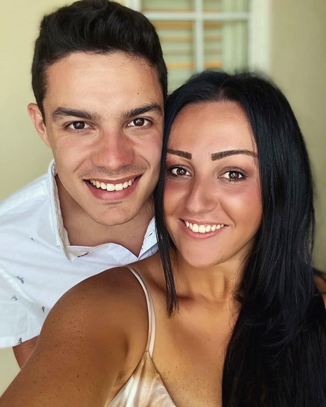 Young couple with spray tans ready for vacation