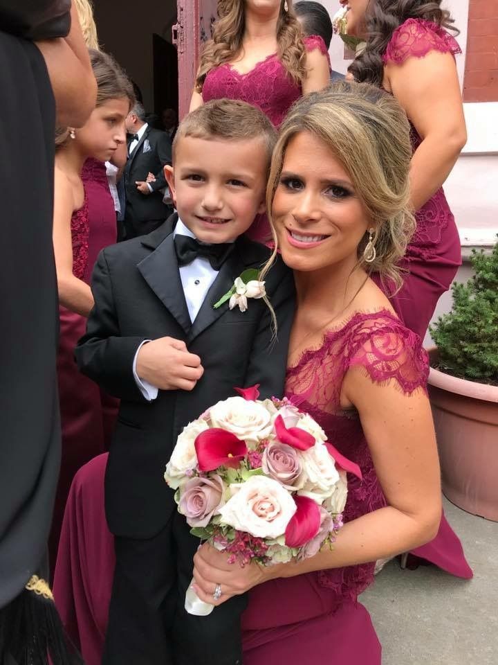 Bridesmaid with a spray tan holding her son